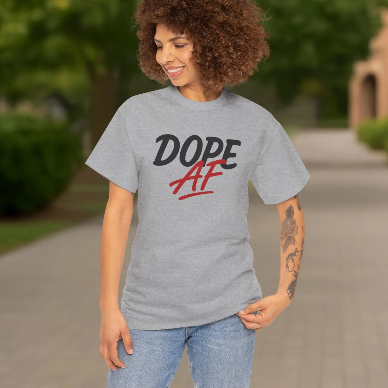 Person wearing a gray t-shirt with 'Dope AF' text outdoors.
