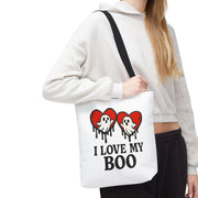 Person holding a tote bag with ghost and heart design and text 'I Love My Boo'.
