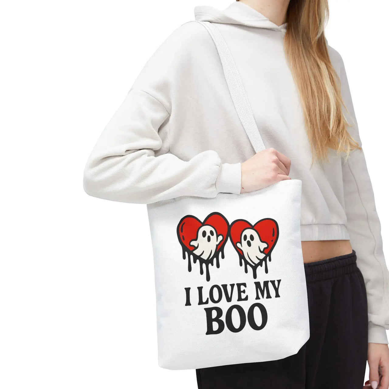 Person holding a tote bag with ghost and heart design and text 'I Love My Boo'.