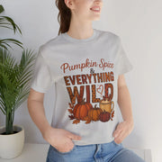 Person wearing a white t-shirt with 'Pumpkin Spice & Everything Wild' text and graphics.