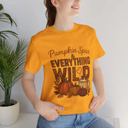 Person wearing a yellow t-shirt with 'Pumpkin Spice & Everything Wild' text and graphics.