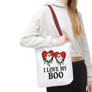 Person holding a tote bag with ghost and heart design and text 'I Love My Boo'.