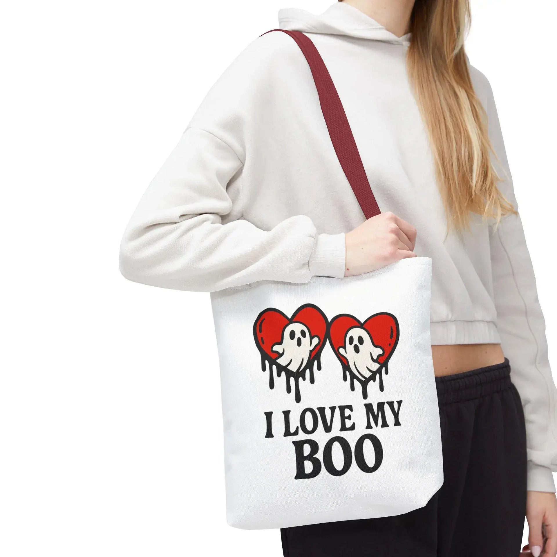 Person holding a tote bag with ghost and heart design and text 'I Love My Boo'.