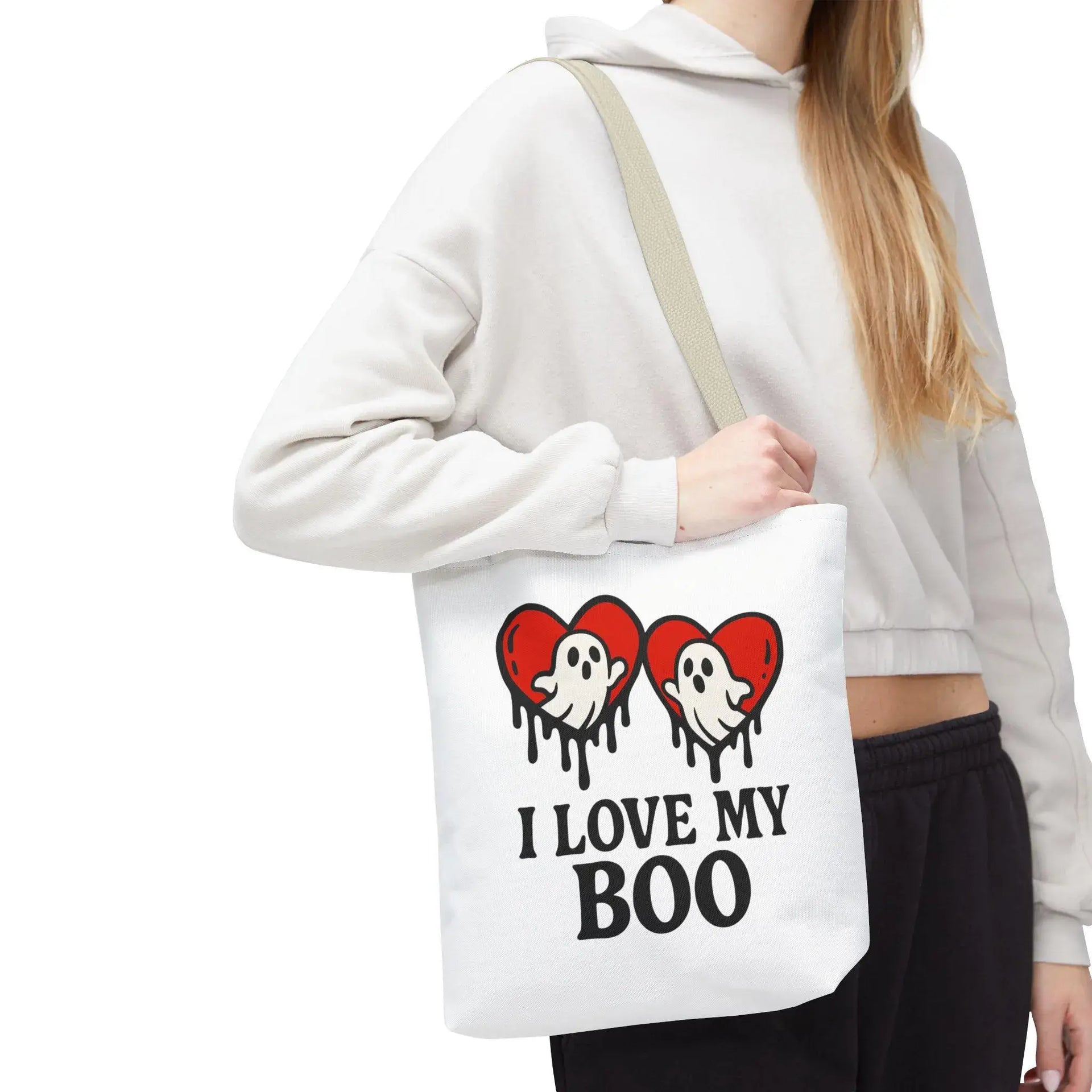 Person holding a tote bag with ghost and heart design and text 'I Love My Boo'.